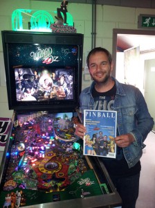 Wizard of Oz graphics animator Jean-Paul de Win posing next to the game he worked on, holding a testprint of PM02. JP also did the finishing touches on the cover.