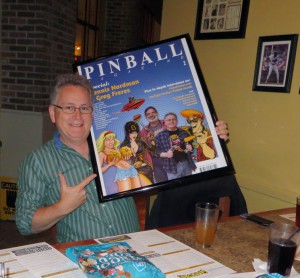 Greg Freres with his framed Pinball Magazine cover poster