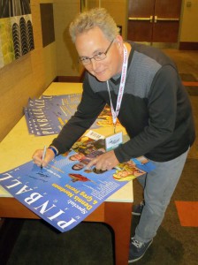 Artist Greg Freres signs the posters as well