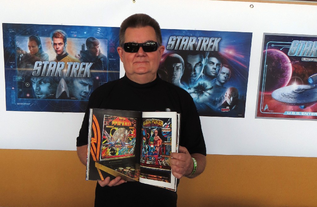 Pinball designer Steve Ritchie with his copy of PINBALL, showing the Firepower page.