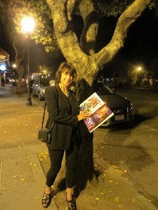 Suzanne Ciani poses with Santiago Ciuffo's PINBALL book, showing the Xenon pages